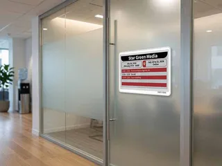 E-ink nameplates and room booking displays in an office workspace